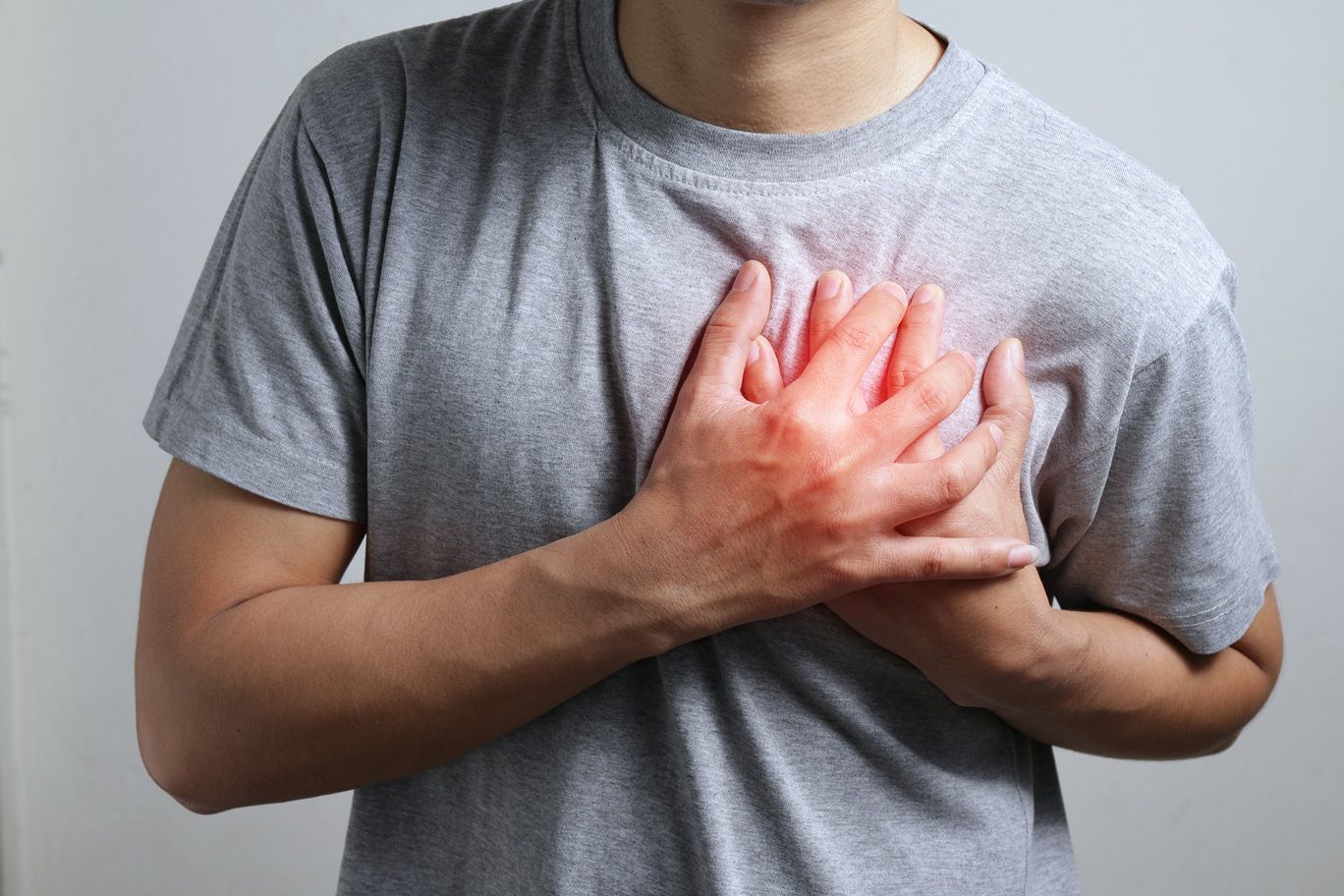 Heart attack problems. Young male suffering from severe chest pa